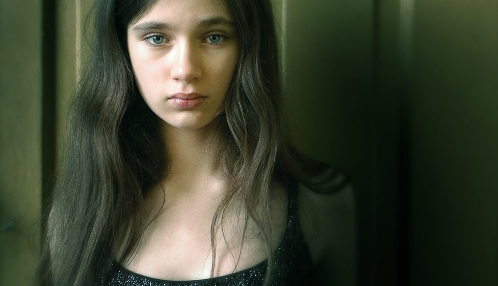 portret młodej dziewczyny na tle drzwi - sesja do portfolio modelki